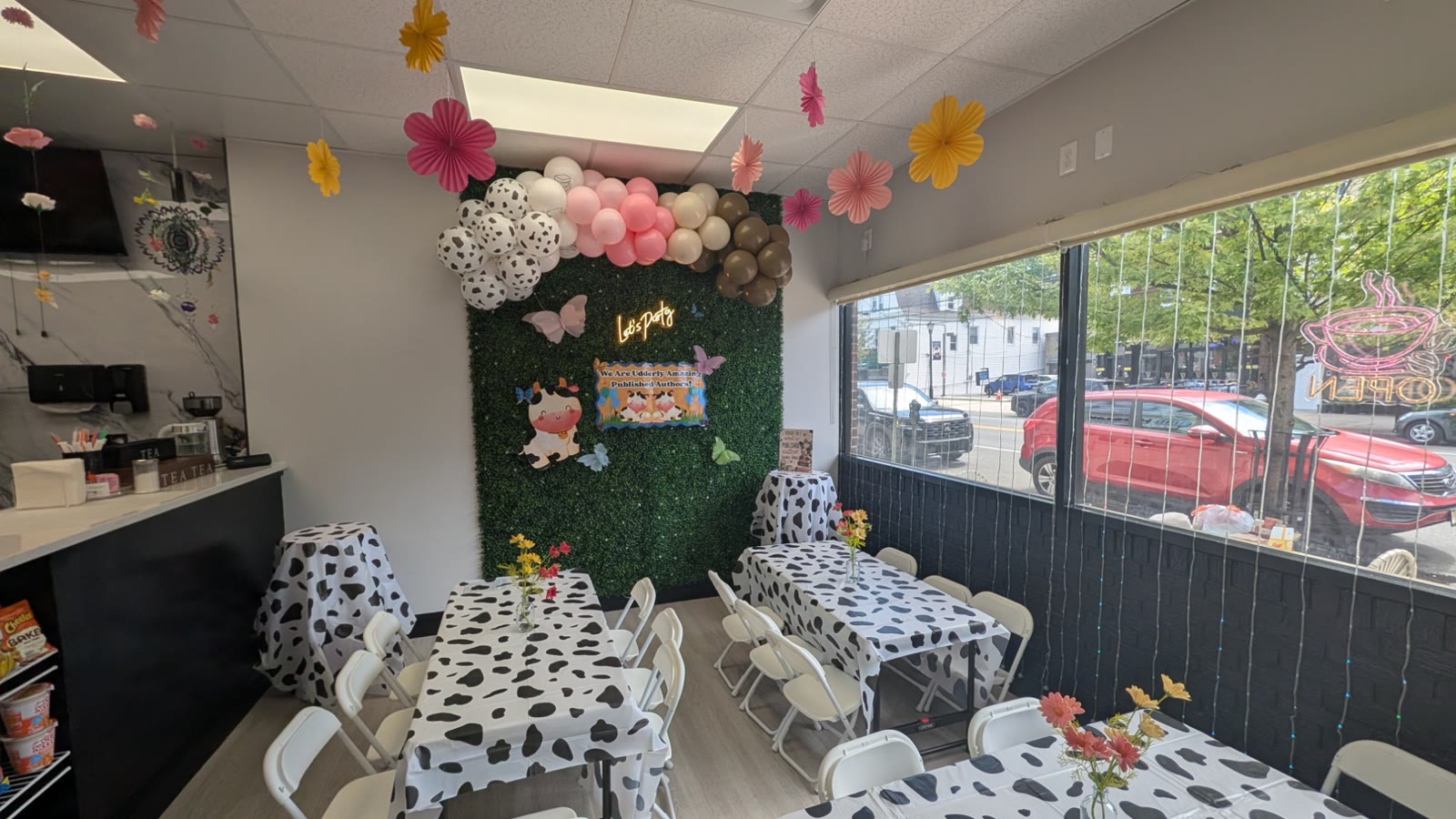 Cow print themed party room with flower decorations at JJ's